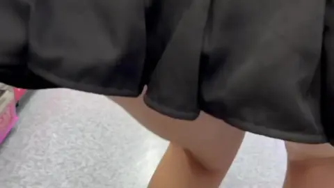 Asian Teen in Black Skirt and Orange Shoes