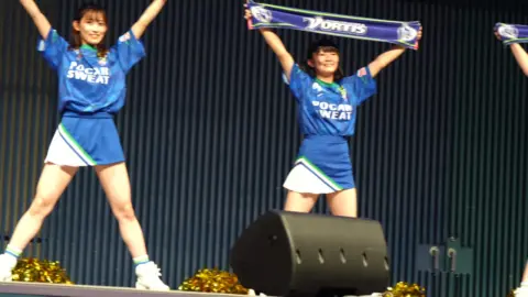 Asian Performers Dance on Stage