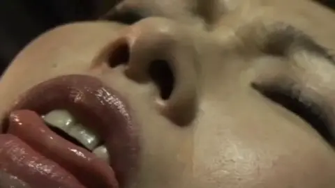 BDSM Scene with Green Corset and Restraint