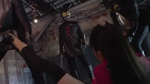 Asian Women in Costumes Industrial Setting