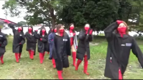 Asian Women in Red Bodysuits Outdoor Dance