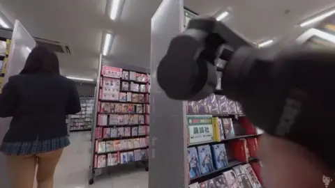 Asian Schoolgirl in Anime Store