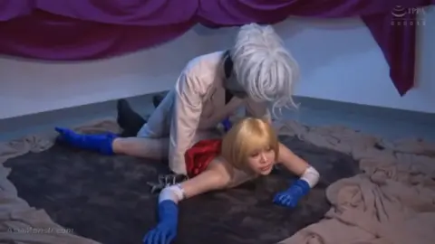 Asian Blonde Bombshell in White Bodysuit with Red Cape