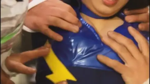 Asian Costumed Performer in Mask and Blue Outfit