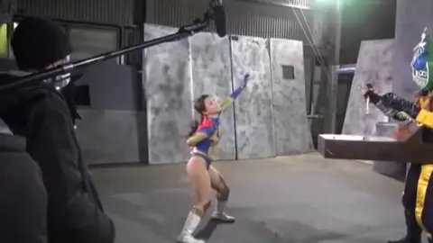 Costumed Characters Interact with Women in Revealing Outfits