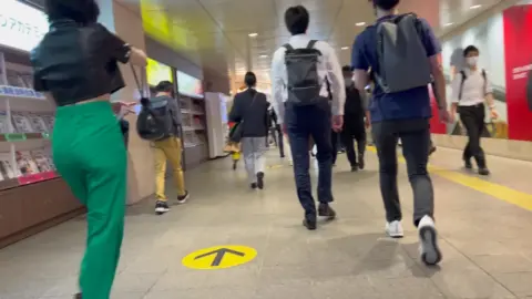 Asian Girl in Green Pants Walking