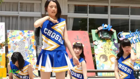 Asian Teen Cheerleaders Dancing Outdoor