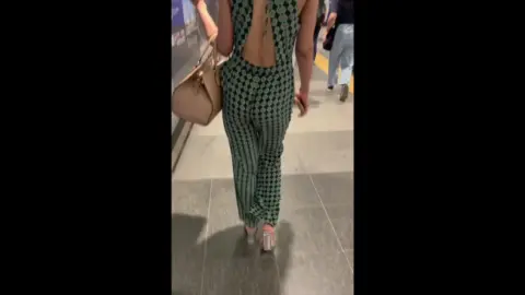 Asian Girl in Backless Top at Public Transportation