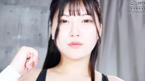 Asian Wrestlers Grappling In Ring