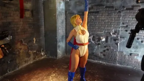 Blonde Asian Performer in Fetish Outfit