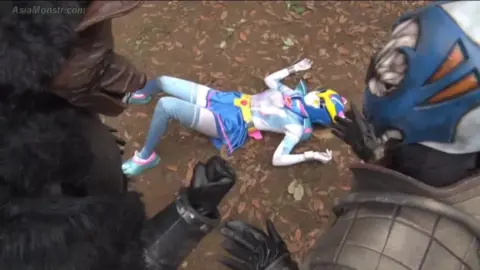 Group Fight Scene with Female on Ground