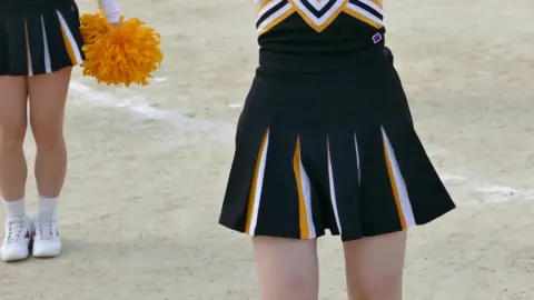 Asian Teen Cheerleaders with Pom-Poms