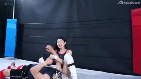 Asian Lesbians in Wrestling Attire Engage in Wrestling Match