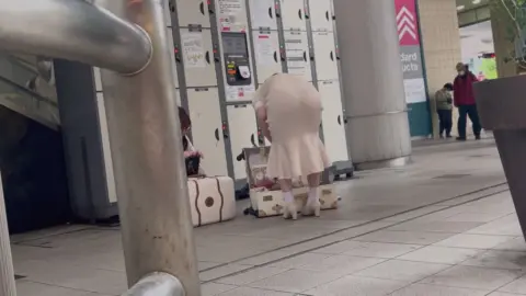 Brunettes in Beige Dresses at Train Station