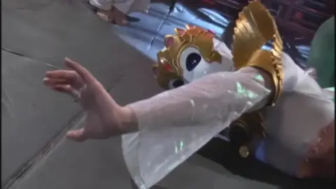 Asian Performers in Masks and White Dresses Dancing