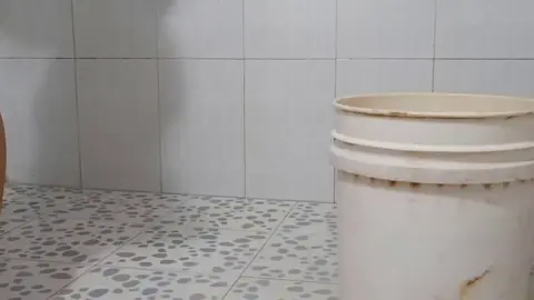 Woman washing face in shower