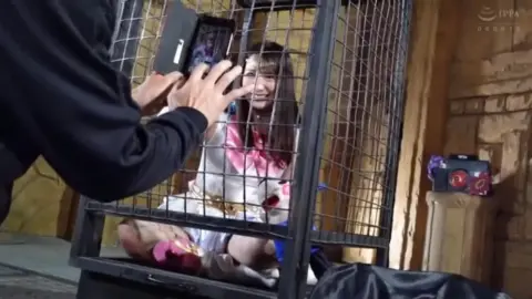 Girls in Cage Posing and Smiling