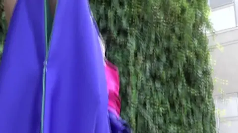 Asian Woman with Purple Hair in Leather Outfit