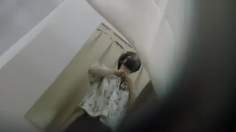 Asian girl in white floral dress undresses