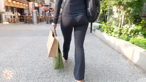Asian Brunette Walking on Street