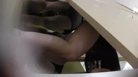 Asian Woman Undresses in Bedroom