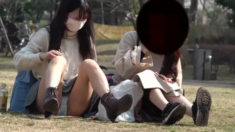 Asian Lesbians Relaxing in the Park
