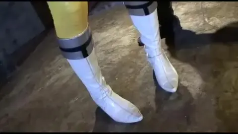 Asian Model in Metallic Costume Performs in Industrial Setting