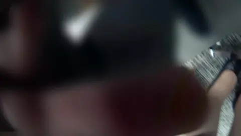 Slim Caucasian Woman in Black Dress Teases in Office Setting