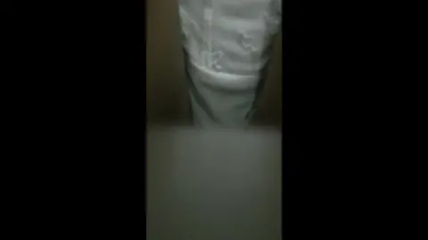 Blonde Woman Undresses in Office Setting