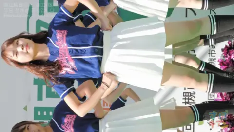 Asian Cheerleaders Outdoor Cheering