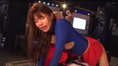 Asian Couple in Superman Costume Engaging in Intimate Acts