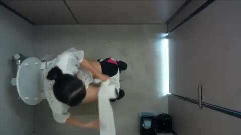 Asian Teen Sitting on Toilet