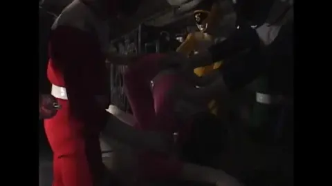 Asian Performers in Colorful Costumes Engage in Restraint