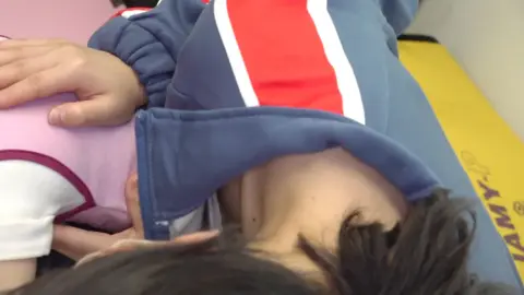 Asian Girls in Face Masks and Striped Jackets