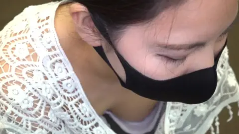 Asian Woman Performs CPR in White Shirt and Shorts