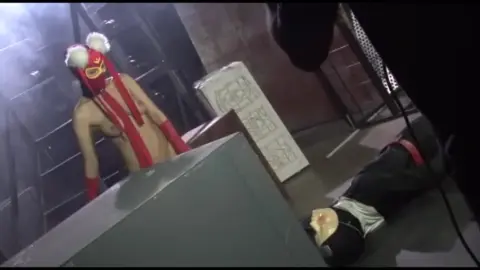 Slim Women in Red Fetish Outfit in Dark Room