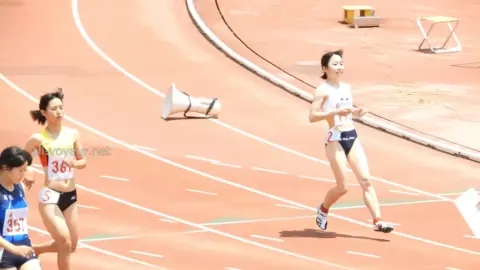 Asian Athletes Running Track