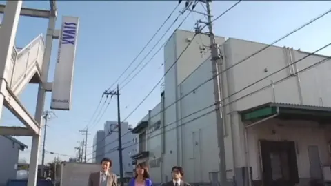Asian Couple in Costumes Outdoors