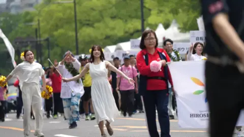 Asian Girls Dancing in White Dresses