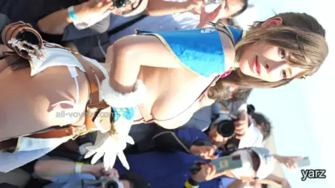 Asian Blonde in Fetish Outfits at Outdoor Event