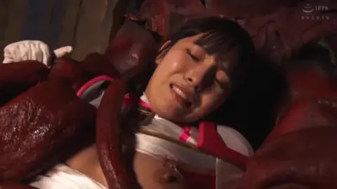Asian girl restrained by tentacles in dark room
