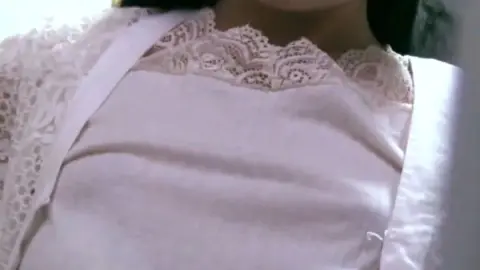 Asian teen bends over in storage room