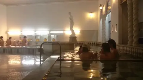 Girls Relaxing in Bathhouse