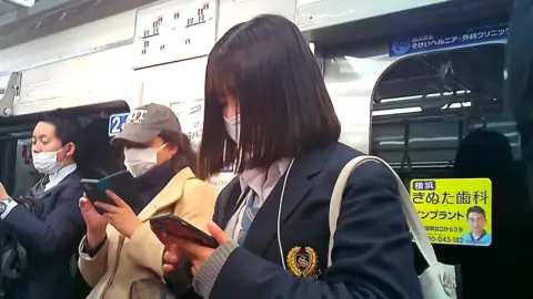 Asian Schoolgirl in Miniskirt on Train