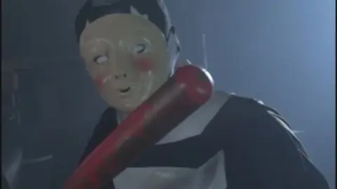 Masked Woman Topless with Man