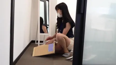 Asian Woman in Office Encounter