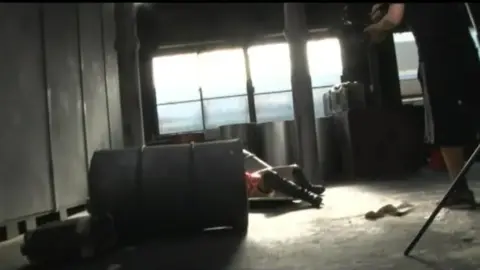 Asian Performers in Red Bodysuits Engaged in BDSM Scenes