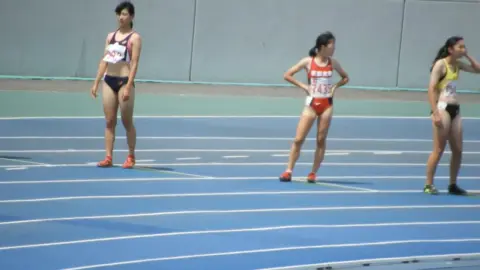 Asian Athletes Running Track