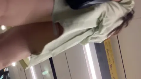 Asian Girl in Mask on Escalator and Elevator