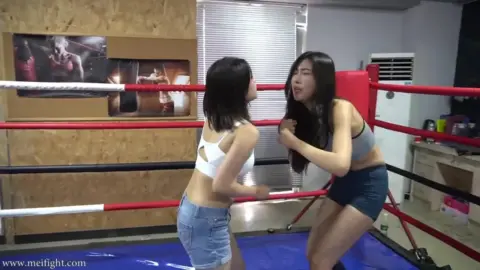 Asian Women Sparring in Boxing Gym